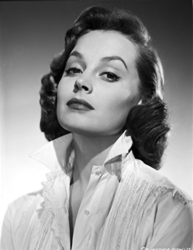 Victoria Shaw posed wearing a white front ruffled pleated button down shirt with the collar popped Photo Print (24 x 30)
